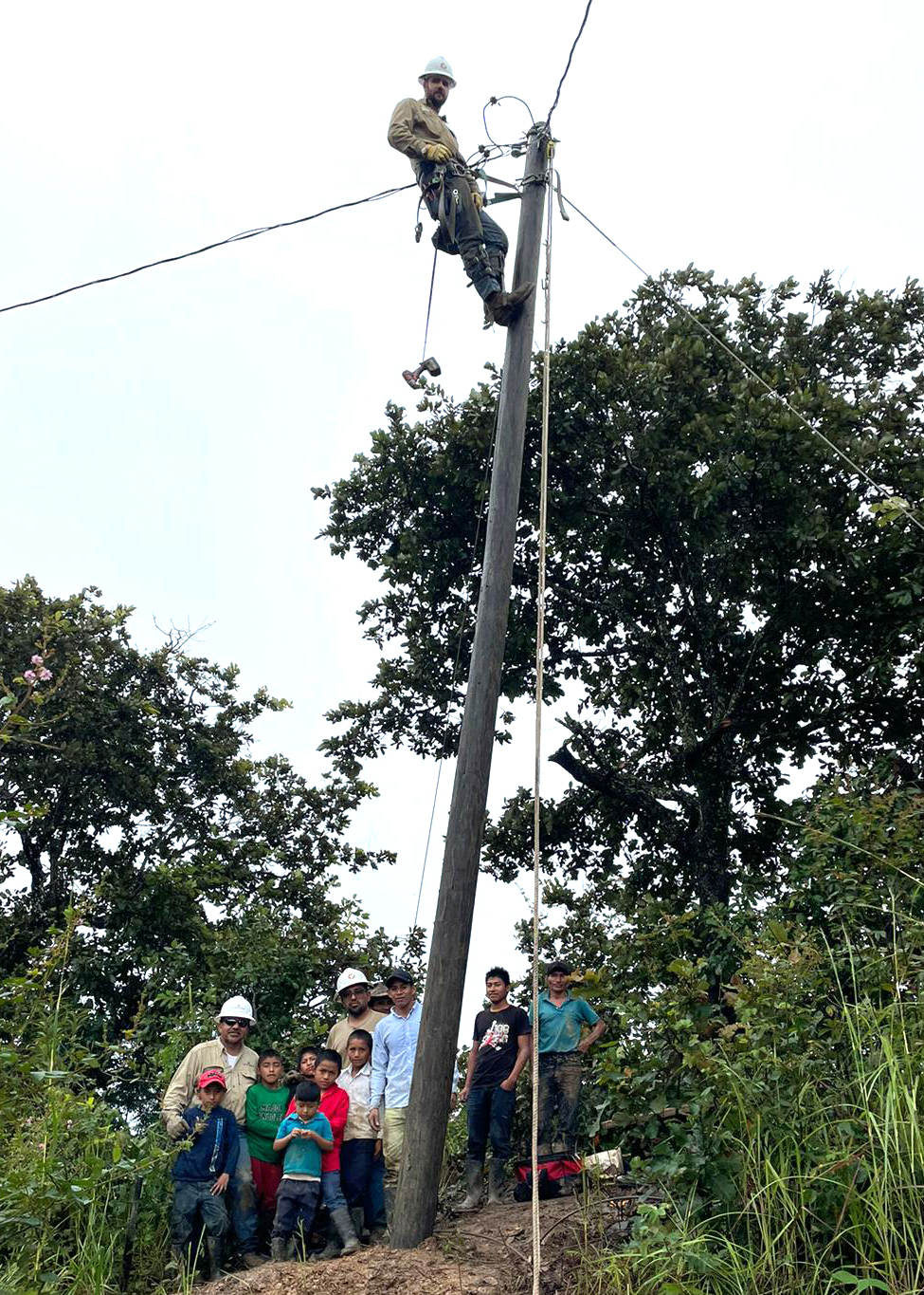 SPEC Linemen with young helpers in Guatemala