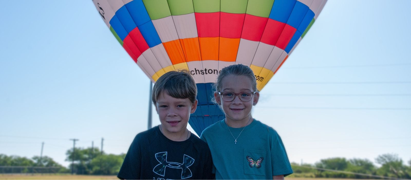 Kids in front of hot air balloon