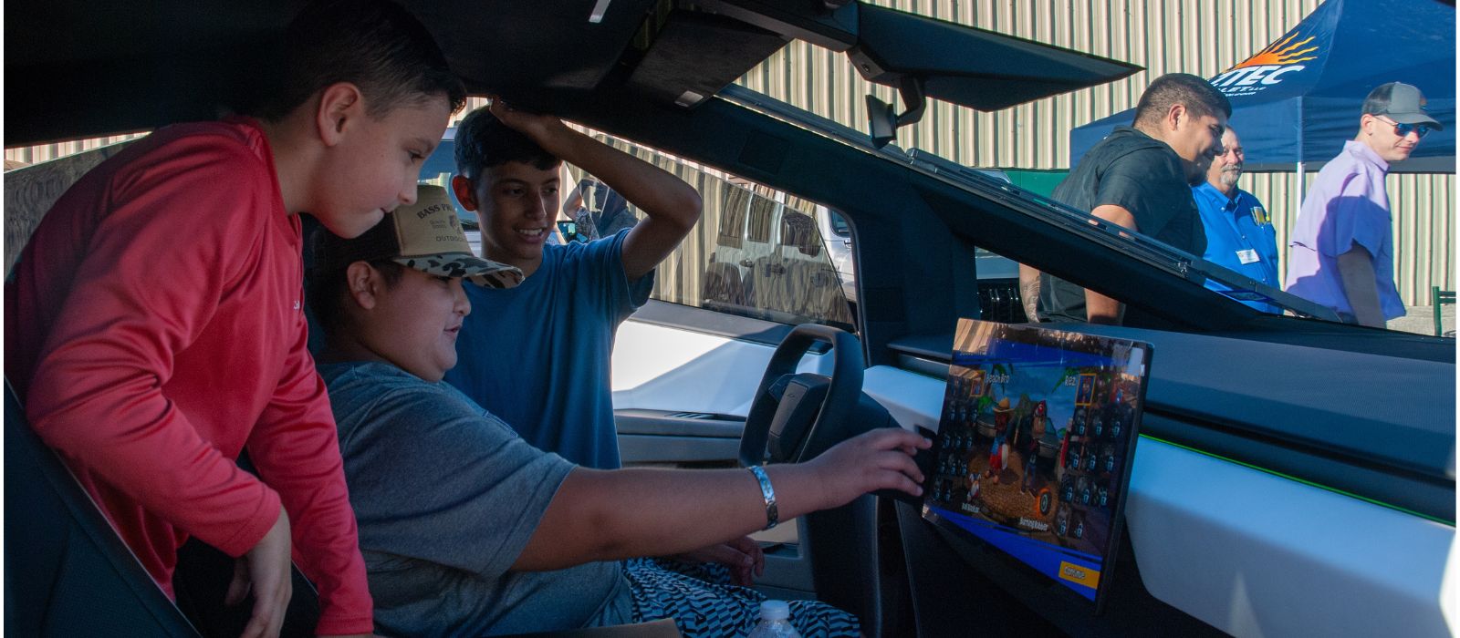 Kids playing video games inside Tesla